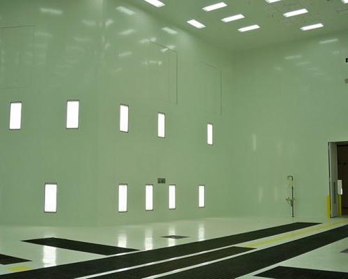 Interior of Gulfstream Paint Hangar. Large empty room with white walls and fluorescent lighting.