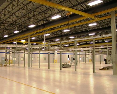 Interior of Turbomeca TMM Manufacturing Facility. Large industrial room with florescent lighting.